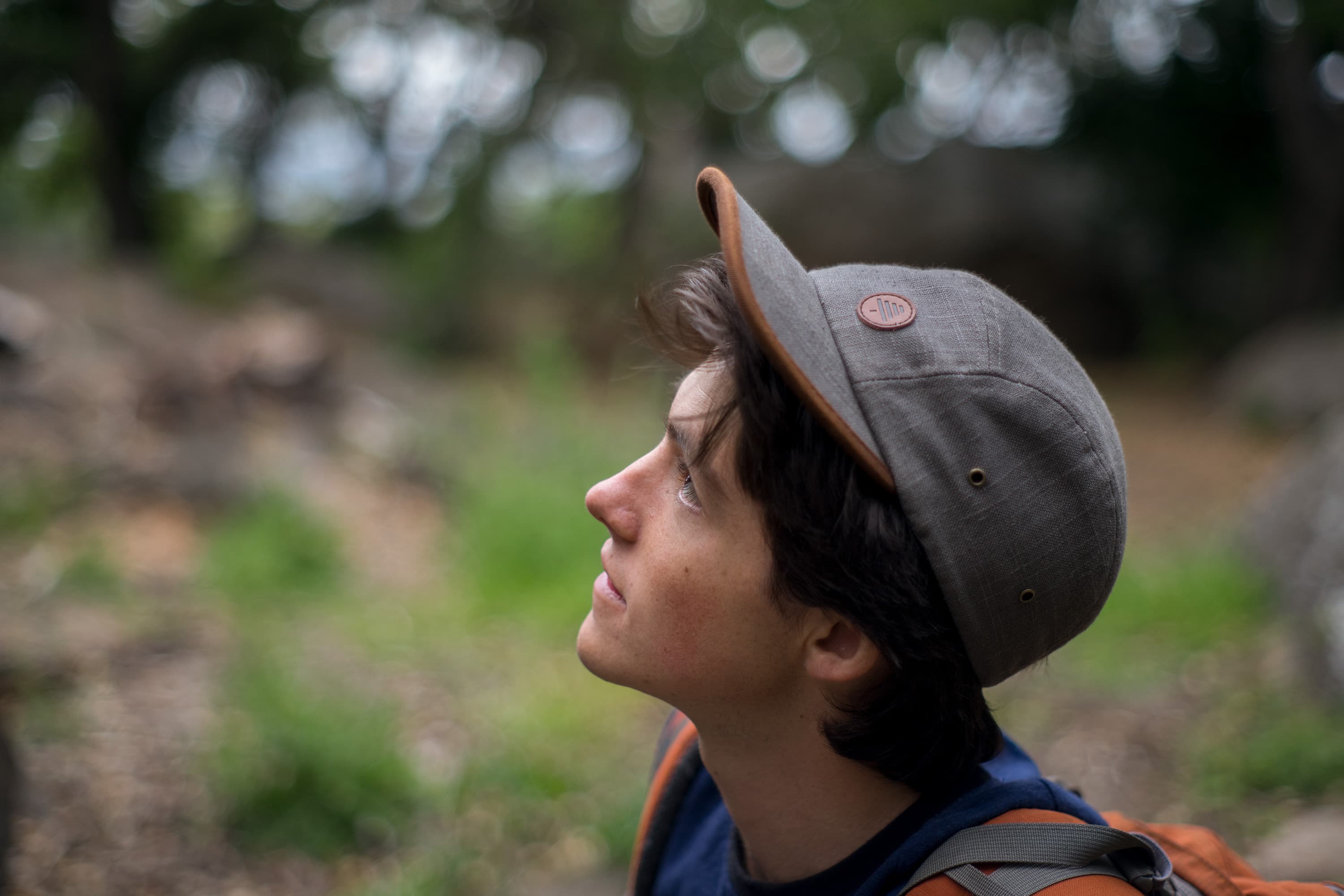 young man looking on a nature hike wearing stone five panel bract apparel cap with embossed logo patch and hemp t-shirt